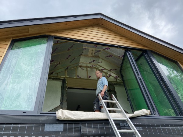 Upper story bifold glass installation